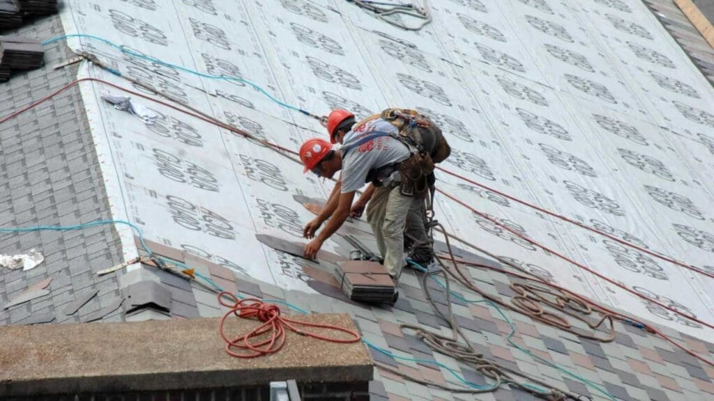 Allen Roofing and Siding roofers wearing safety gear working on a roof