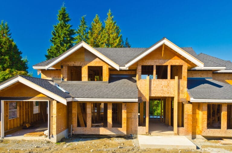 new home under construction with shingle roofing