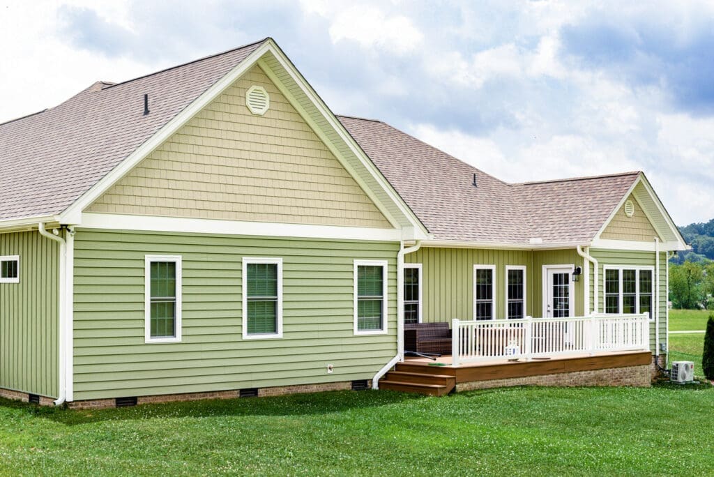 Home with lap vinyl siding in yellow and green