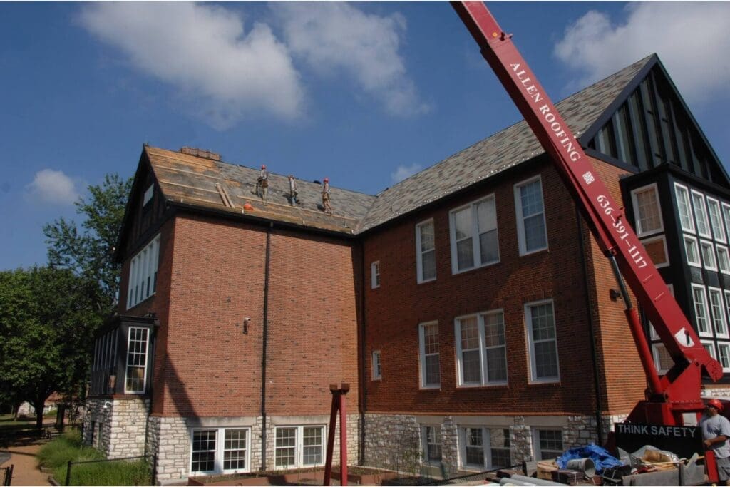 Allen Roofing crane in front of school